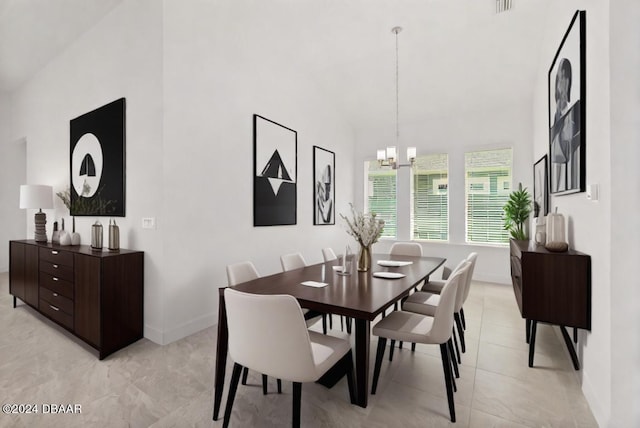 dining area with baseboards, high vaulted ceiling, light tile patterned flooring, and an inviting chandelier