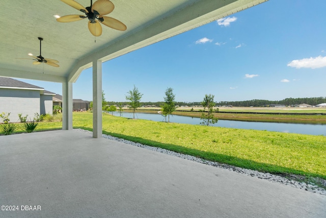 view of patio / terrace featuring ceiling fan and a water view