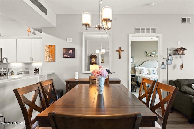 dining area featuring visible vents and a chandelier