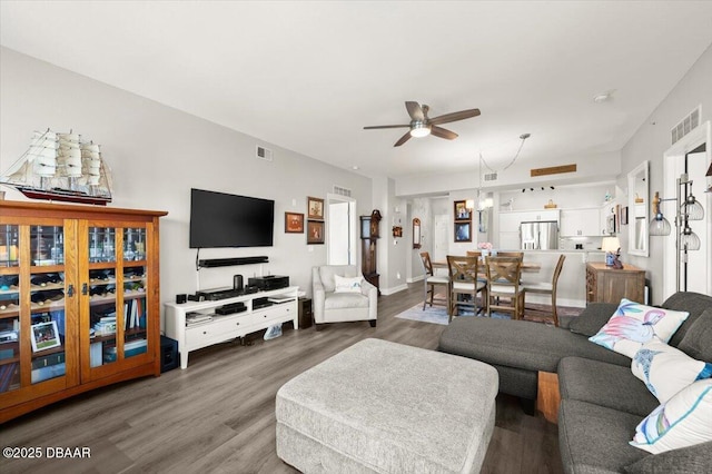 living room featuring visible vents, wood finished floors, and ceiling fan