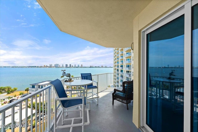 balcony with a water view and a city view