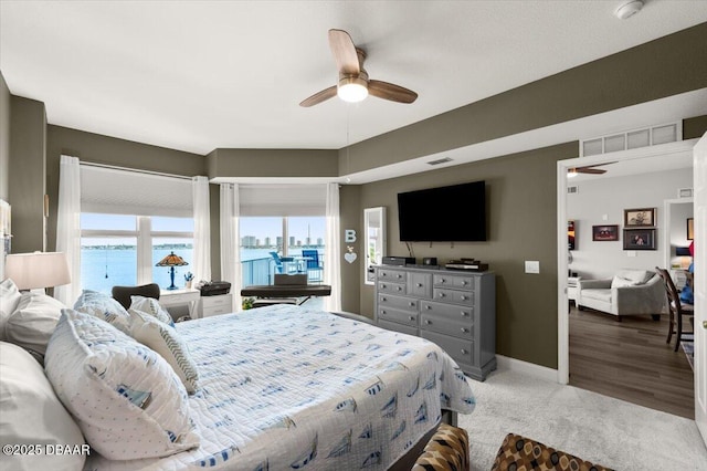 bedroom featuring carpet, visible vents, a ceiling fan, and baseboards