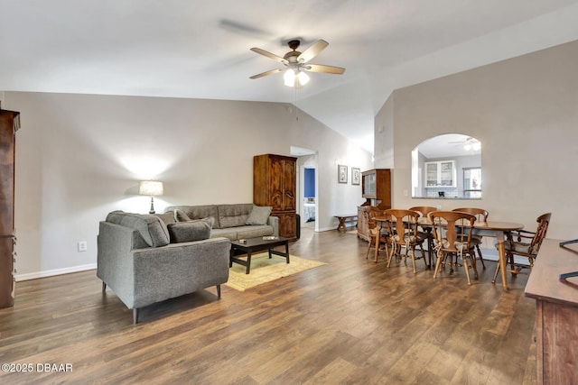 living room featuring dark wood-type flooring, ceiling fan, and lofted ceiling