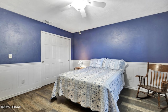 bedroom featuring ceiling fan, a closet, and dark hardwood / wood-style floors