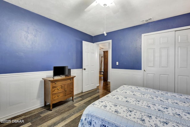 bedroom with ceiling fan, a closet, and dark hardwood / wood-style floors