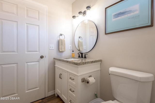 bathroom featuring hardwood / wood-style floors, vanity, and toilet