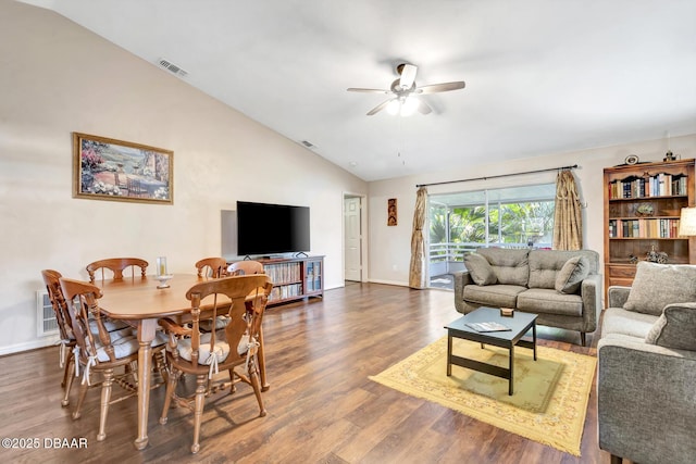 living room featuring ceiling fan, dark hardwood / wood-style floors, and vaulted ceiling