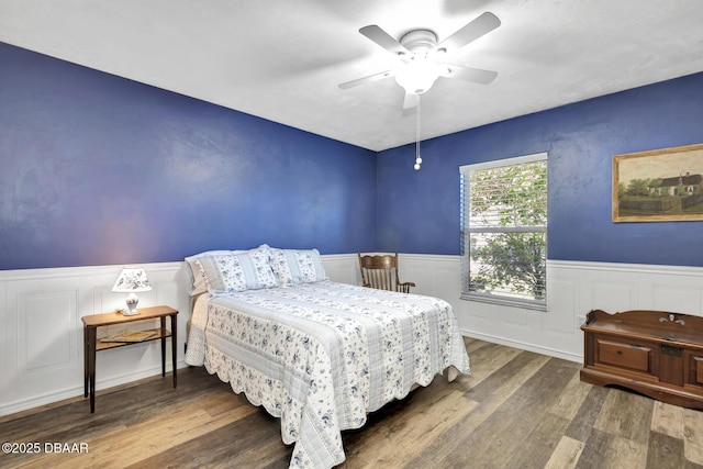 bedroom with ceiling fan and dark hardwood / wood-style flooring