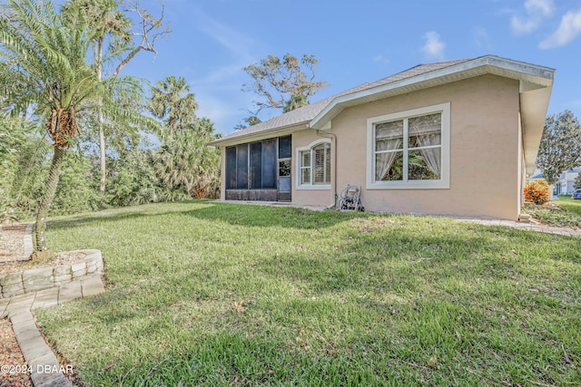 back of house featuring a sunroom and a yard