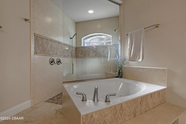 bathroom featuring independent shower and bath and tile patterned floors