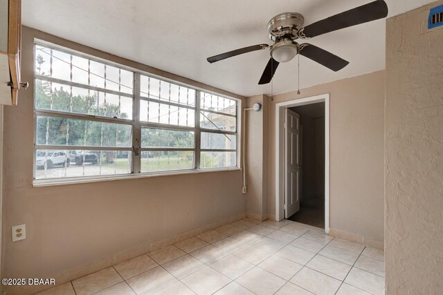 634 Aberdeen St, Daytona Beach, FL 32114 - empty room with a ceiling fan, light tile patterned flooring, and baseboards
