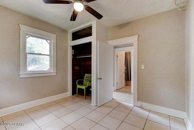 634 Aberdeen St, Daytona Beach, FL 32114 - unfurnished bedroom with light tile patterned floors, baseboards, a closet, and a ceiling fan