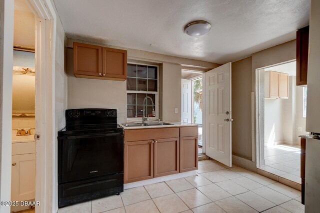 634 Aberdeen St, Daytona Beach, FL 32114 - kitchen featuring black / electric stove, a sink, light countertops, and healthy amount of natural light