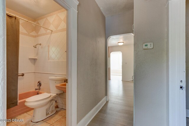 634 Aberdeen St, Daytona Beach, FL 32114 - bathroom with toilet, shower / tub combo, tile patterned floors, and a textured wall