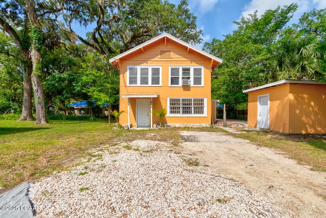 634 Aberdeen St, Daytona Beach, FL 32114 - view of front of property with an outbuilding, stucco siding, a front yard, and driveway