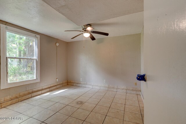 634 Aberdeen St, Daytona Beach, FL 32114 - empty room with light tile patterned flooring, a ceiling fan, and a textured ceiling
