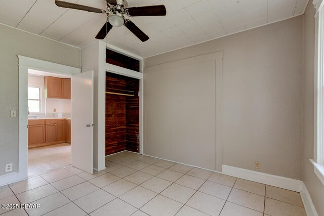 634 Aberdeen St, Daytona Beach, FL 32114 - unfurnished bedroom featuring light tile patterned flooring, a closet, baseboards, and ceiling fan