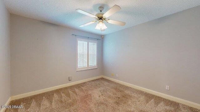 empty room featuring carpet floors, a textured ceiling, and baseboards