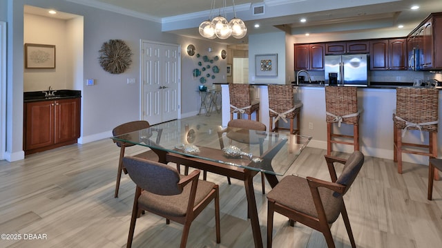 2403 S Atlantic Ave Unit 605, Daytona Beach, FL 32118 - dining room featuring ornamental molding, a chandelier, baseboards, recessed lighting, and light wood-type flooring