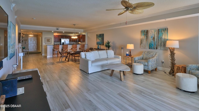 2403 S Atlantic Ave Unit 605, Daytona Beach, FL 32118 - living room with ornamental molding, a ceiling fan, baseboards, and light wood-style flooring