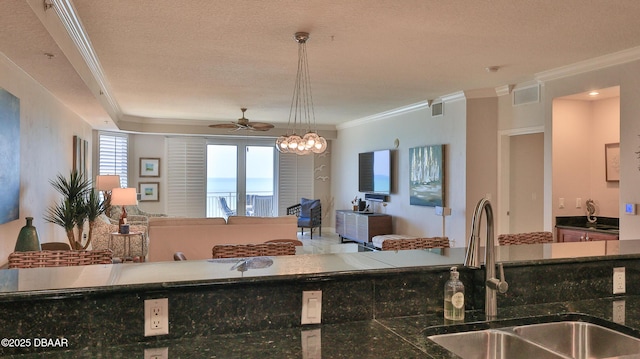 2403 S Atlantic Ave Unit 605, Daytona Beach, FL 32118 - kitchen with a sink, open floor plan, crown molding, a ceiling fan, and pendant lighting