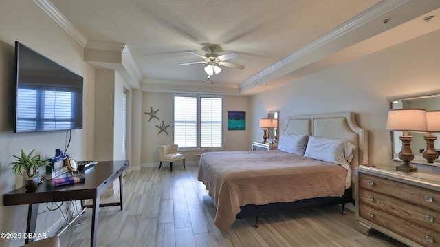 2403 S Atlantic Ave Unit 605, Daytona Beach, FL 32118 - bedroom with light wood-style flooring, ornamental molding, baseboards, and a ceiling fan