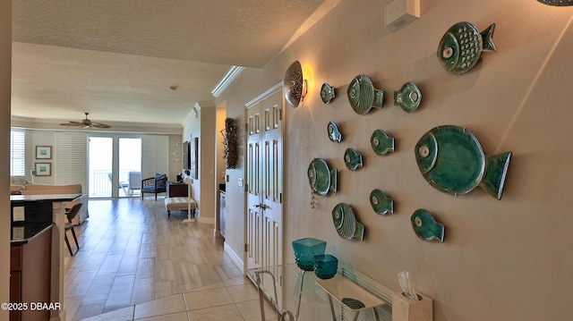2403 S Atlantic Ave Unit 605, Daytona Beach, FL 32118 - hallway with a textured ceiling, baseboards, and ornamental molding