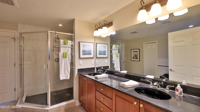 2403 S Atlantic Ave Unit 605, Daytona Beach, FL 32118 - bathroom with a stall shower, double vanity, a textured ceiling, recessed lighting, and tile patterned floors