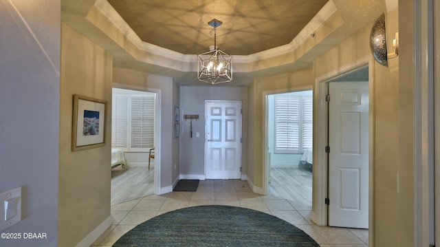 2403 S Atlantic Ave Unit 605, Daytona Beach, FL 32118 - entryway featuring a tray ceiling, a chandelier, light tile patterned floors, and baseboards