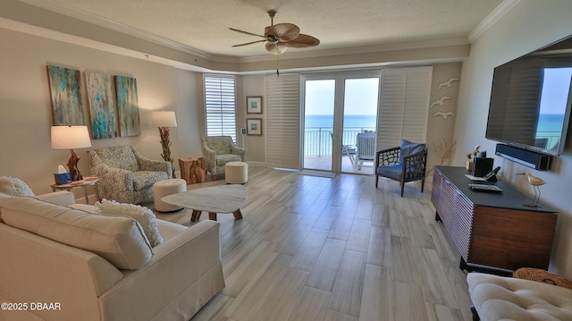 2403 S Atlantic Ave Unit 605, Daytona Beach, FL 32118 - living room with crown molding, a ceiling fan, light wood-type flooring, and a textured ceiling