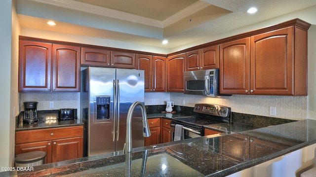 2403 S Atlantic Ave Unit 605, Daytona Beach, FL 32118 - kitchen with appliances with stainless steel finishes, crown molding, tasteful backsplash, dark stone countertops, and recessed lighting