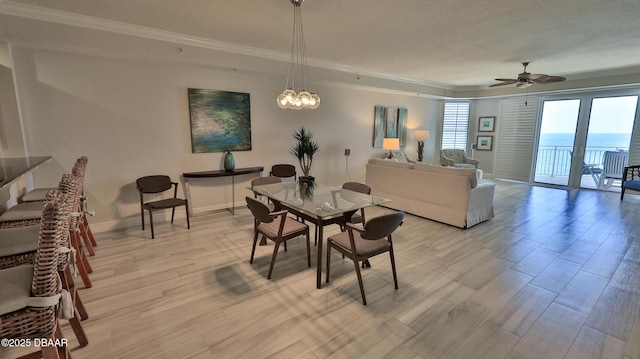 2403 S Atlantic Ave Unit 605, Daytona Beach, FL 32118 - dining room with ornamental molding, light wood finished floors, a ceiling fan, baseboards, and a textured ceiling