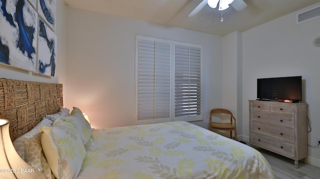 2403 S Atlantic Ave Unit 605, Daytona Beach, FL 32118 - bedroom with wood finished floors, ceiling fan, and baseboards