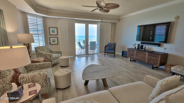 2403 S Atlantic Ave Unit 605, Daytona Beach, FL 32118 - living area with ornamental molding, ceiling fan, plenty of natural light, wood finished floors, and a textured ceiling