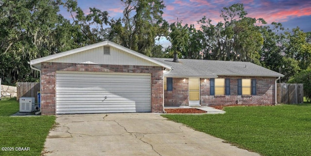 ranch-style home with a yard and a garage