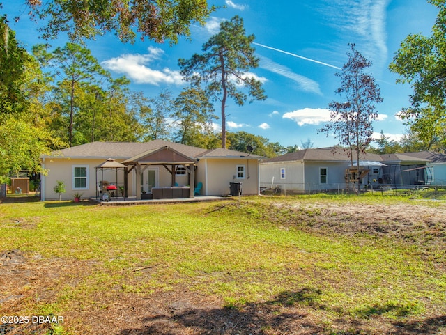 rear view of house with a yard