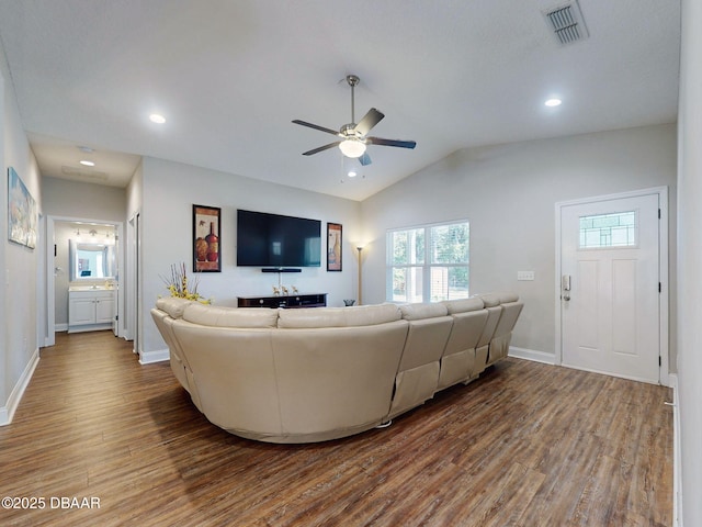 living room with lofted ceiling, ceiling fan, and hardwood / wood-style floors