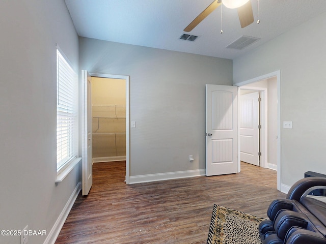 sitting room with ceiling fan and dark hardwood / wood-style floors