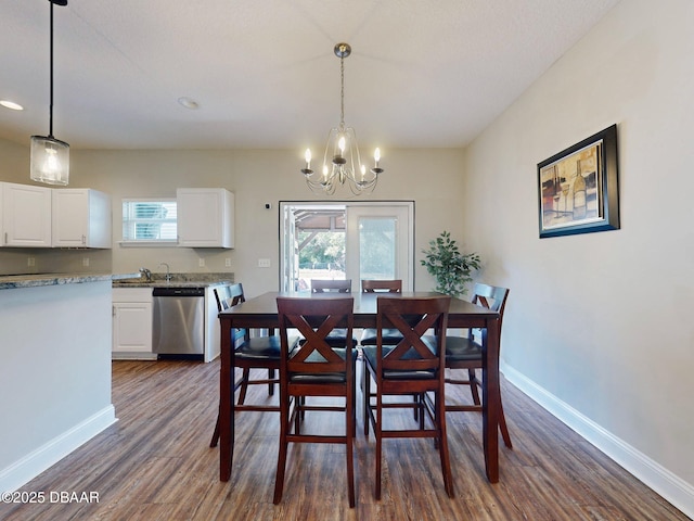 dining room featuring a notable chandelier and dark hardwood / wood-style floors