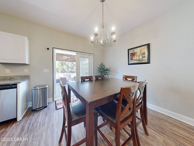 dining space with a notable chandelier and light wood-type flooring