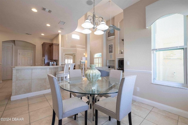 dining area featuring plenty of natural light, light tile patterned floors, and an inviting chandelier