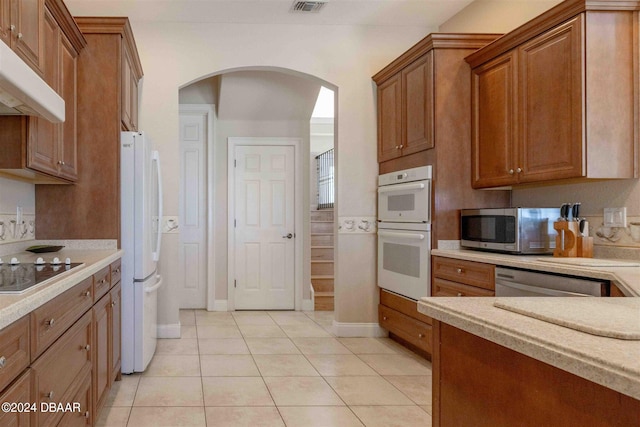 kitchen with stainless steel appliances and light tile patterned flooring