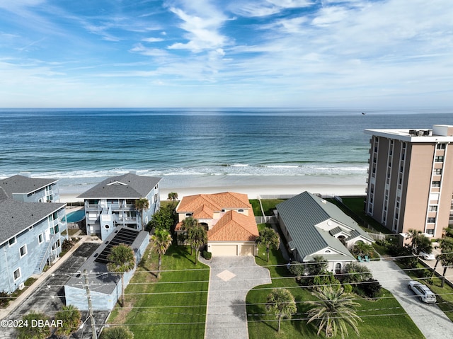 bird's eye view featuring a water view and a beach view