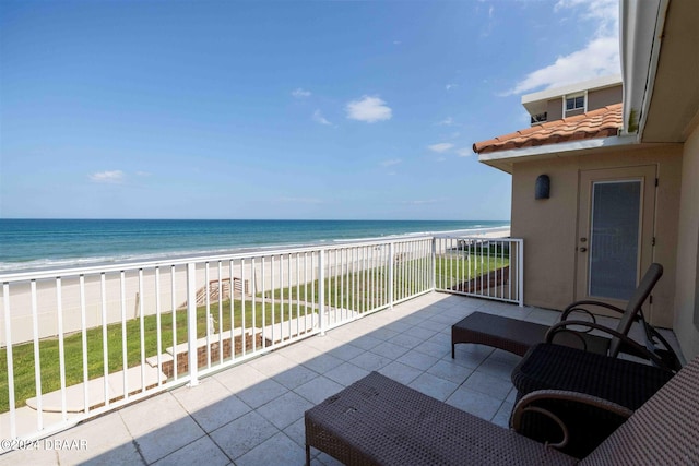 balcony with a beach view and a water view