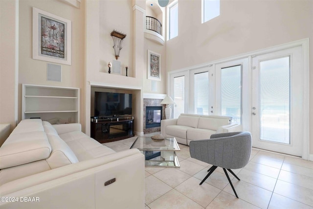 tiled living room featuring a high ceiling and french doors