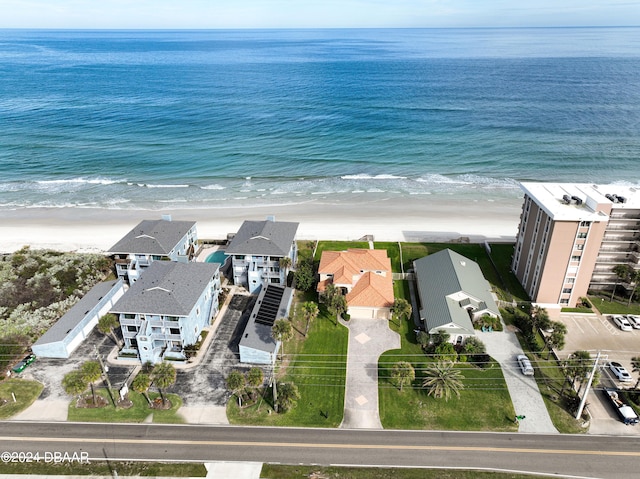 birds eye view of property featuring a beach view and a water view