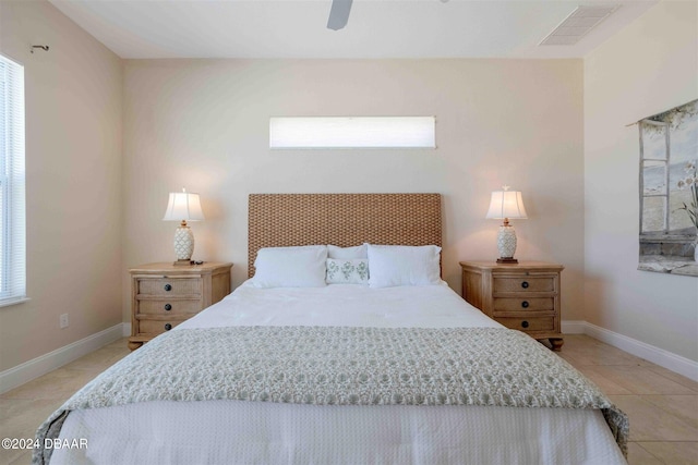 tiled bedroom with ceiling fan