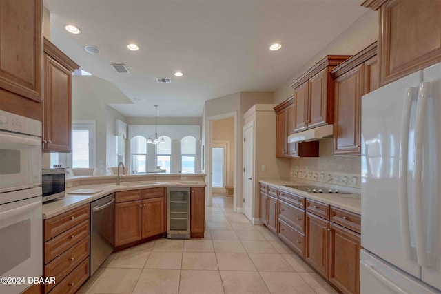 kitchen with stainless steel appliances, light tile patterned flooring, wine cooler, sink, and a notable chandelier