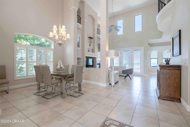 dining space with built in features, light tile patterned floors, a high ceiling, and plenty of natural light