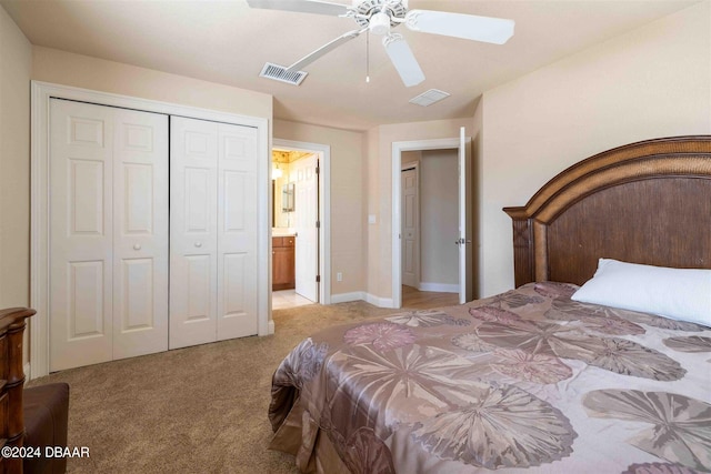 bedroom featuring connected bathroom, a closet, light carpet, and ceiling fan